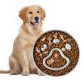 Load image into Gallery viewer, A golden retriever sits beside a stainless steel slow feed dog bowl filled with brown kibble, shaped like a paw print, with some treats on top.