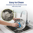 Load image into Gallery viewer, A person washes a shiny dog bowl lid with a blue sponge under running water, illustrating easy cleaning and dishwasher safety.