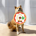 Load image into Gallery viewer, A Shiba Inu holds a dog plush toy labeled "Sniff out the toppings!" with various toppings illustrated on it.