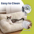 Load image into Gallery viewer, A relaxed cat lounges on a cozy, easy-to-clean cat couch with highlighted features: a washable cover and removable filling.