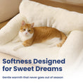 Load image into Gallery viewer, An orange and white cat comfortably lies on a plush, cream-colored cat sofa bed, emphasizing a cozy and inviting atmosphere.