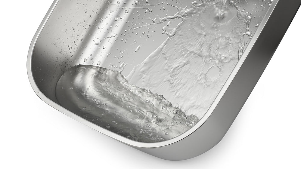 Close-up of water splashing in a big cat litter box.