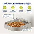 Load image into Gallery viewer, A tilted stainless steel cat food dispenser designed for smooth food flow, portion control, and preventing feline acne. Whisker friendly design.

