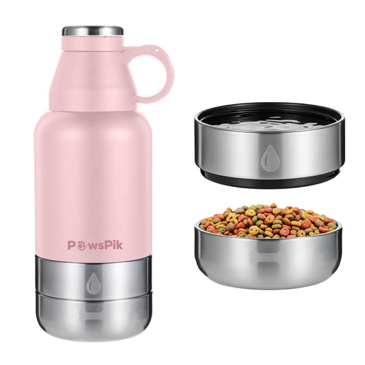 A pink PawsPik stainless steel pet water bottle beside two metal bowls, one filled with colorful pet food and the other with water.
