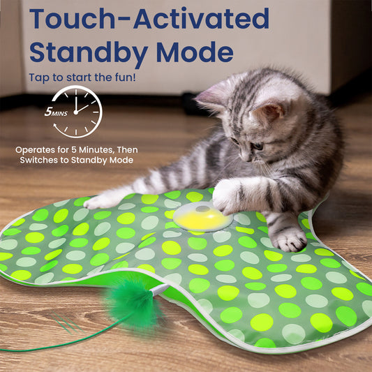 A playful kitten taps a colorful, touch-activated cat toy with a yellow button, ready for fun and engaging playtime.