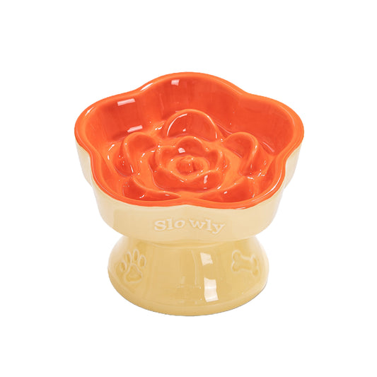Cat Slow Feeder made with ceramic, featuring an orange interior, a yellow base, and the word "Slowly" embossed on the side.