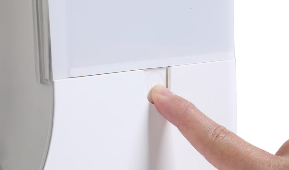 A finger presses a white button on a sleek, modern microchip pet feeder against a plain background.