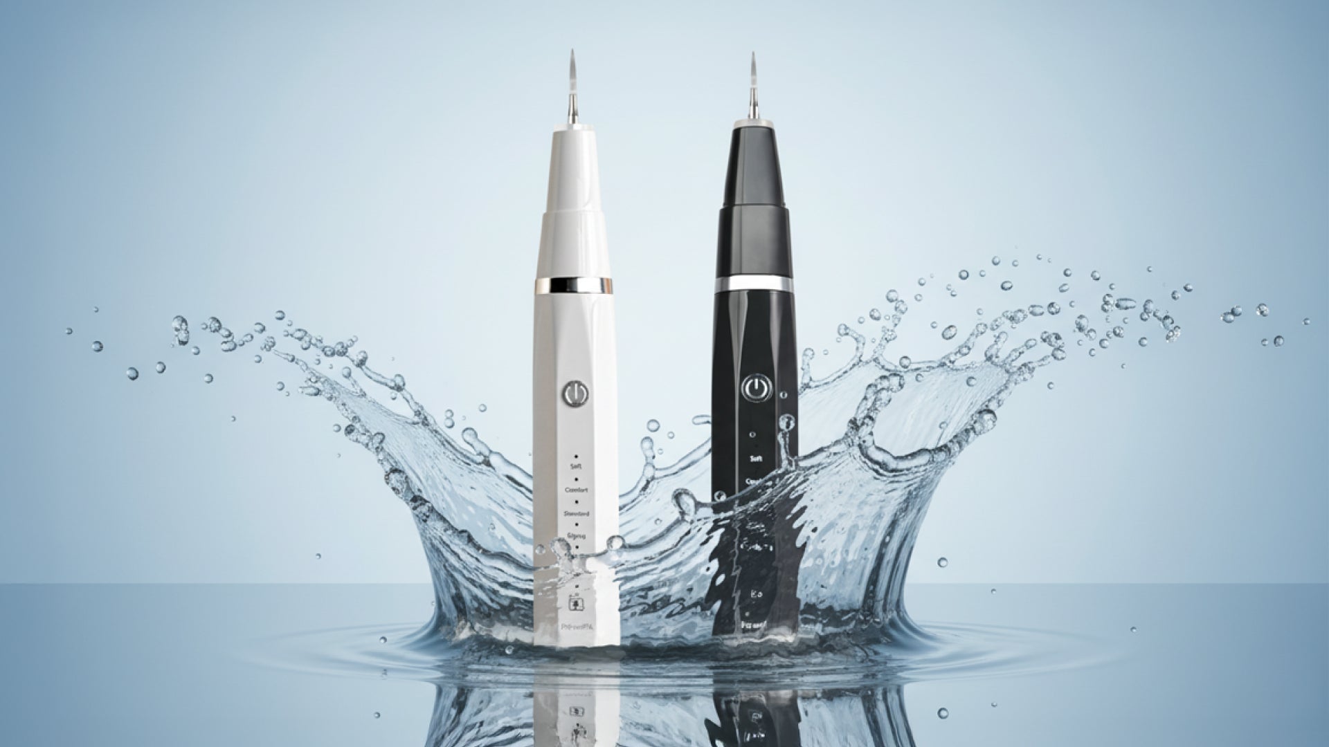 Two ultrasonic dog plaque remover tools, one white and one black, stand upright in splashing water against a light blue background, conveying a fresh, modern feel.